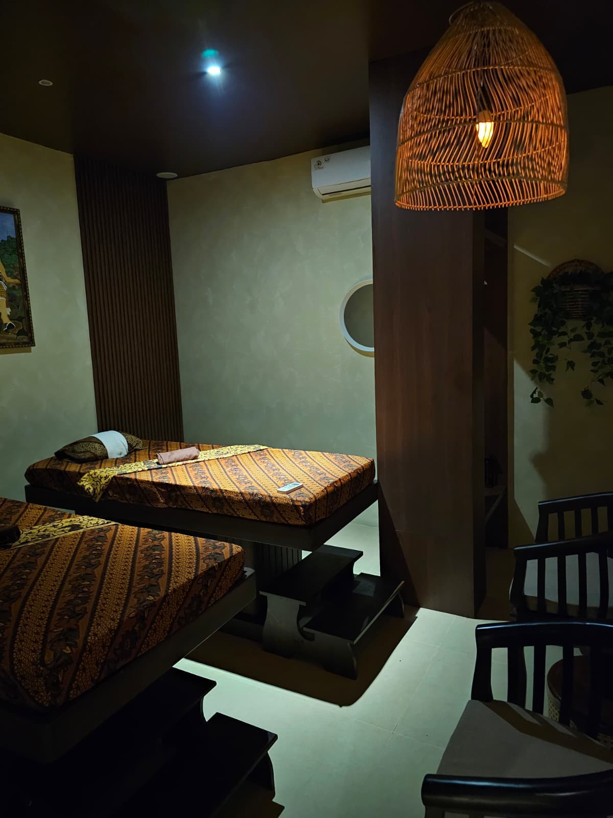Private luxury treatment room with warm ambient lighting prepared for Djaya Signature massage ritual in Batam